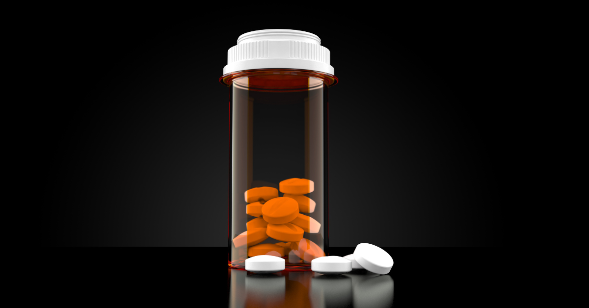 Recognizing Drug Paraphernalia How to Tell If Someone Is on Drugs - a prescription pill bottle with no label and miscellaneous pills inside of it and outside of it