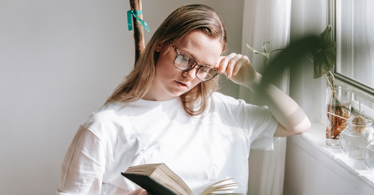 A woman reading debating between DBT and CBT therapy for her addiction and mental health disorders