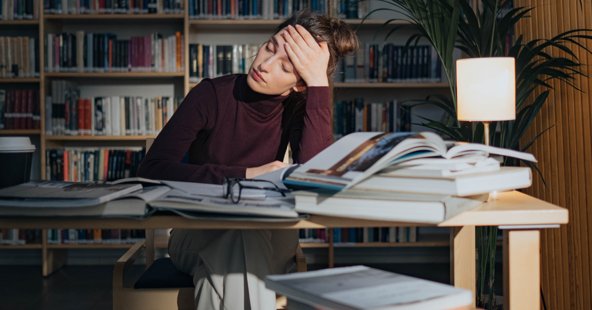 A college student or professional woman struggling with productivity pills